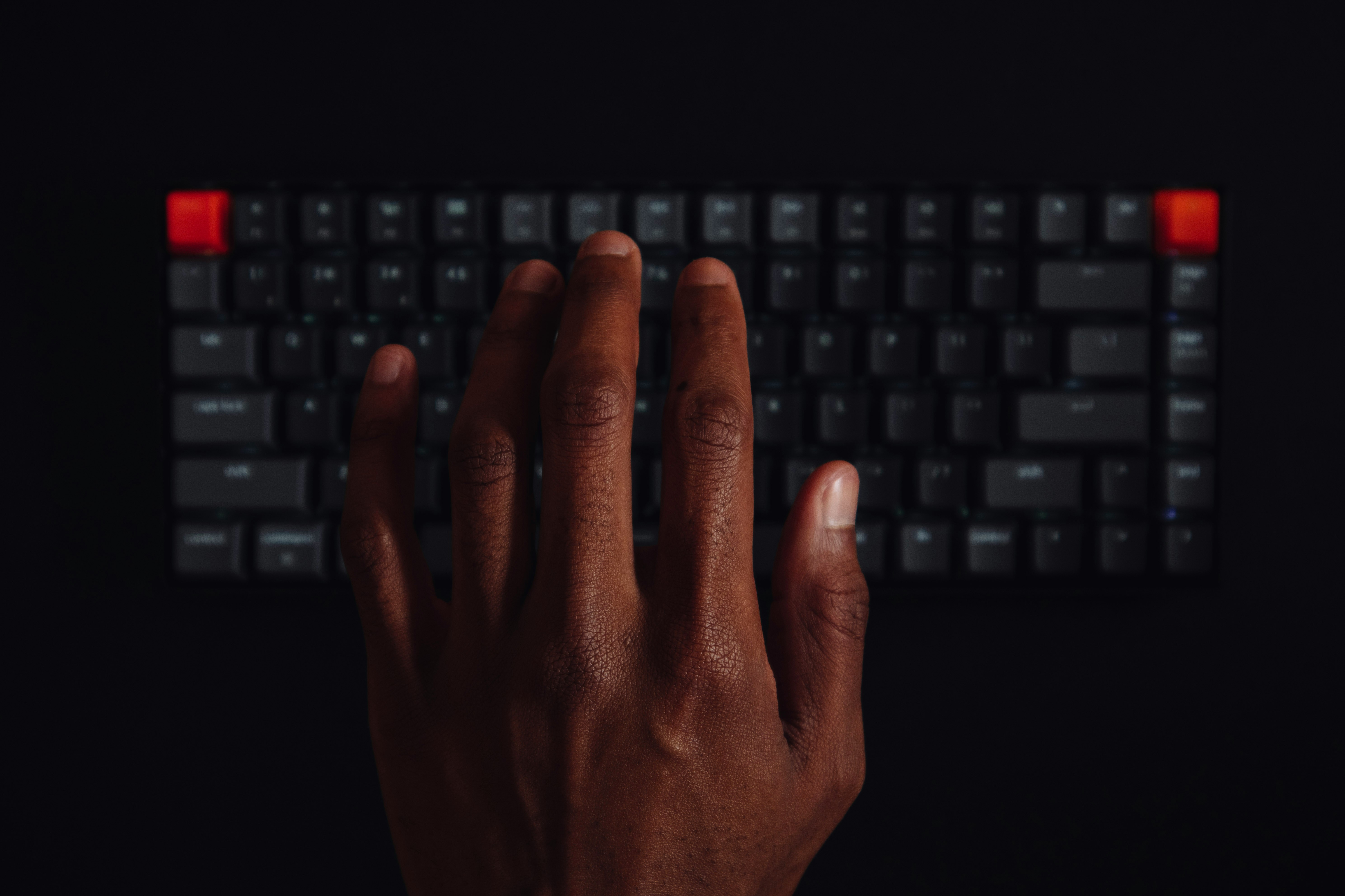 persons hand on black computer keyboard