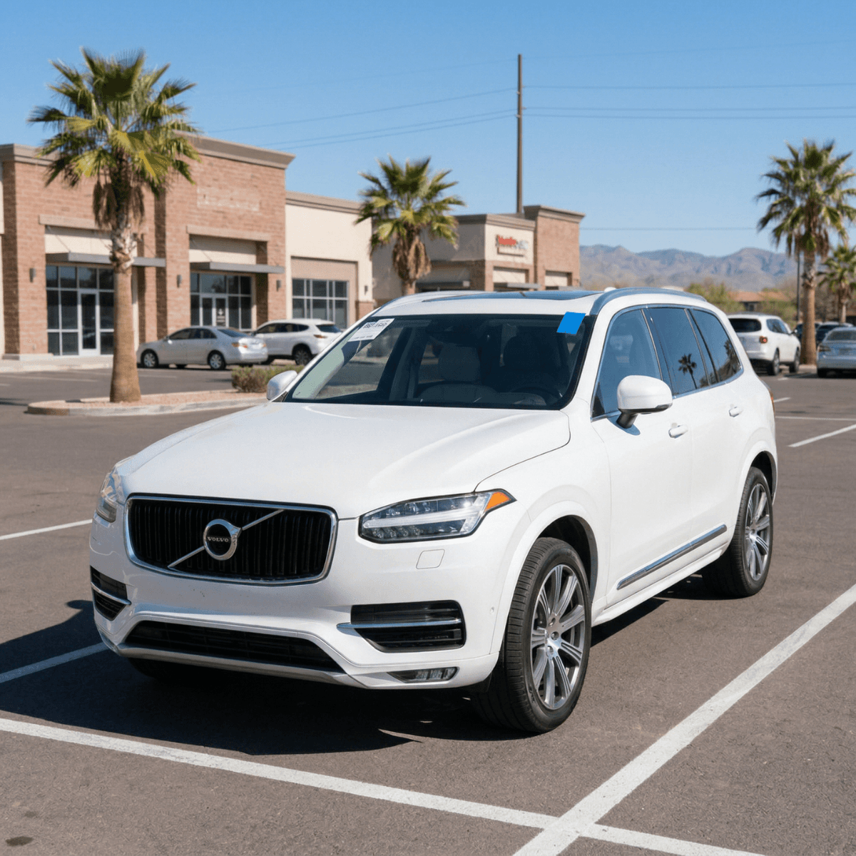 White Volvo XC60 after receiving a precision windshield installation at a Holbrook shopping center