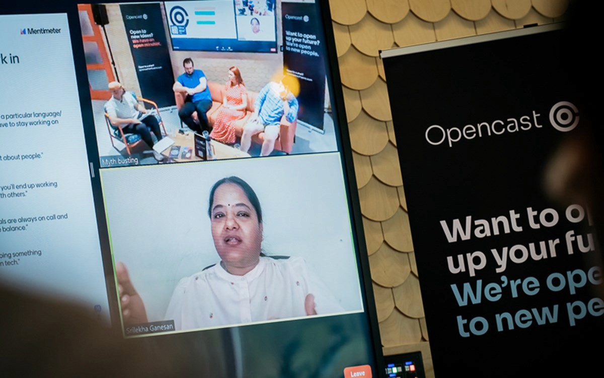 Video call screen showing a panel discussion with four people and an Opencast banner in the background.