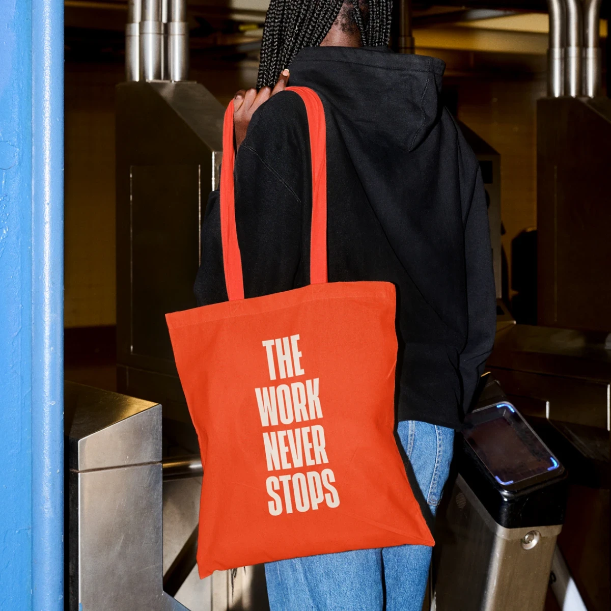 Orange National Partnership tote bag reading The Work Never Stops.