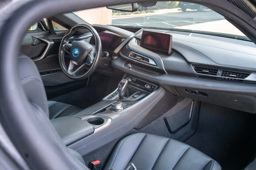 Close-up of the BMW i8 interior highlighting the digital dashboard, leather seats, and high-tech cockpit.