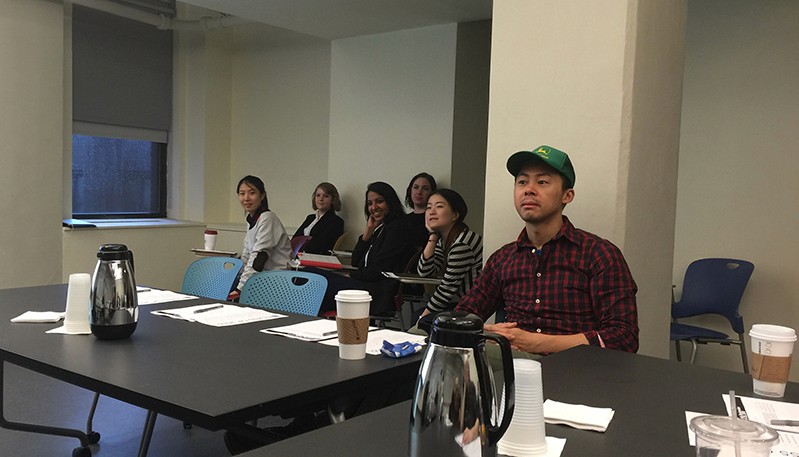 A photo of a group of students sitting in a conference room.