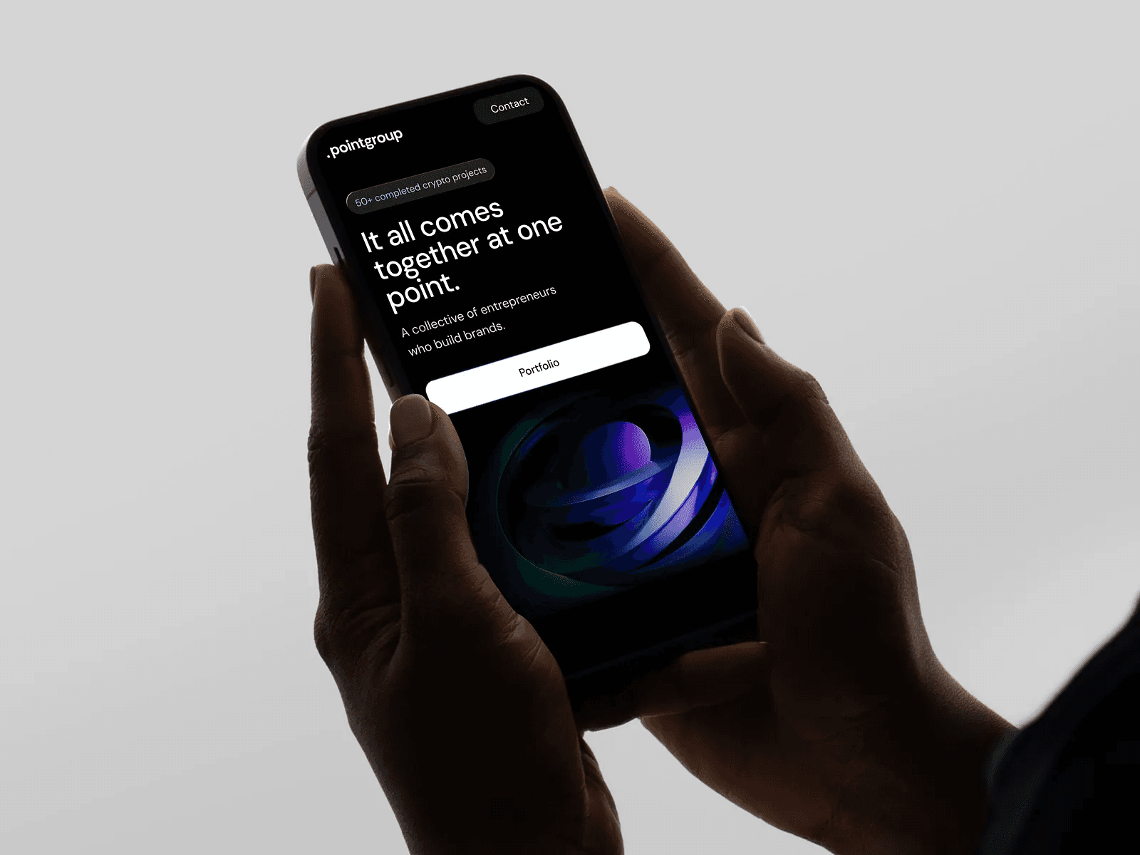Team of three employees having a meeting at a table in a bright modern office.
