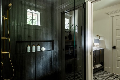 The master bathroom of the Sammamish Remodel by interior design + professional organizing firm, Elegant Simplicity. Girls bathroom redone with black and gold tones, edgy and modern