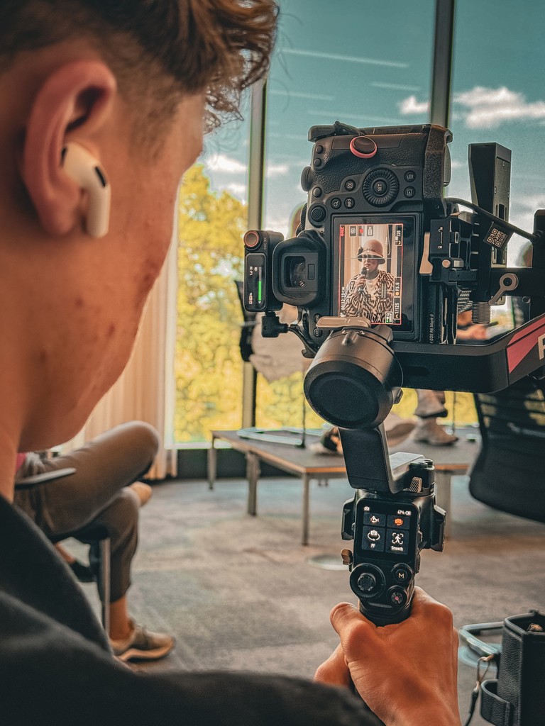 two people looking at a tablet and smiling