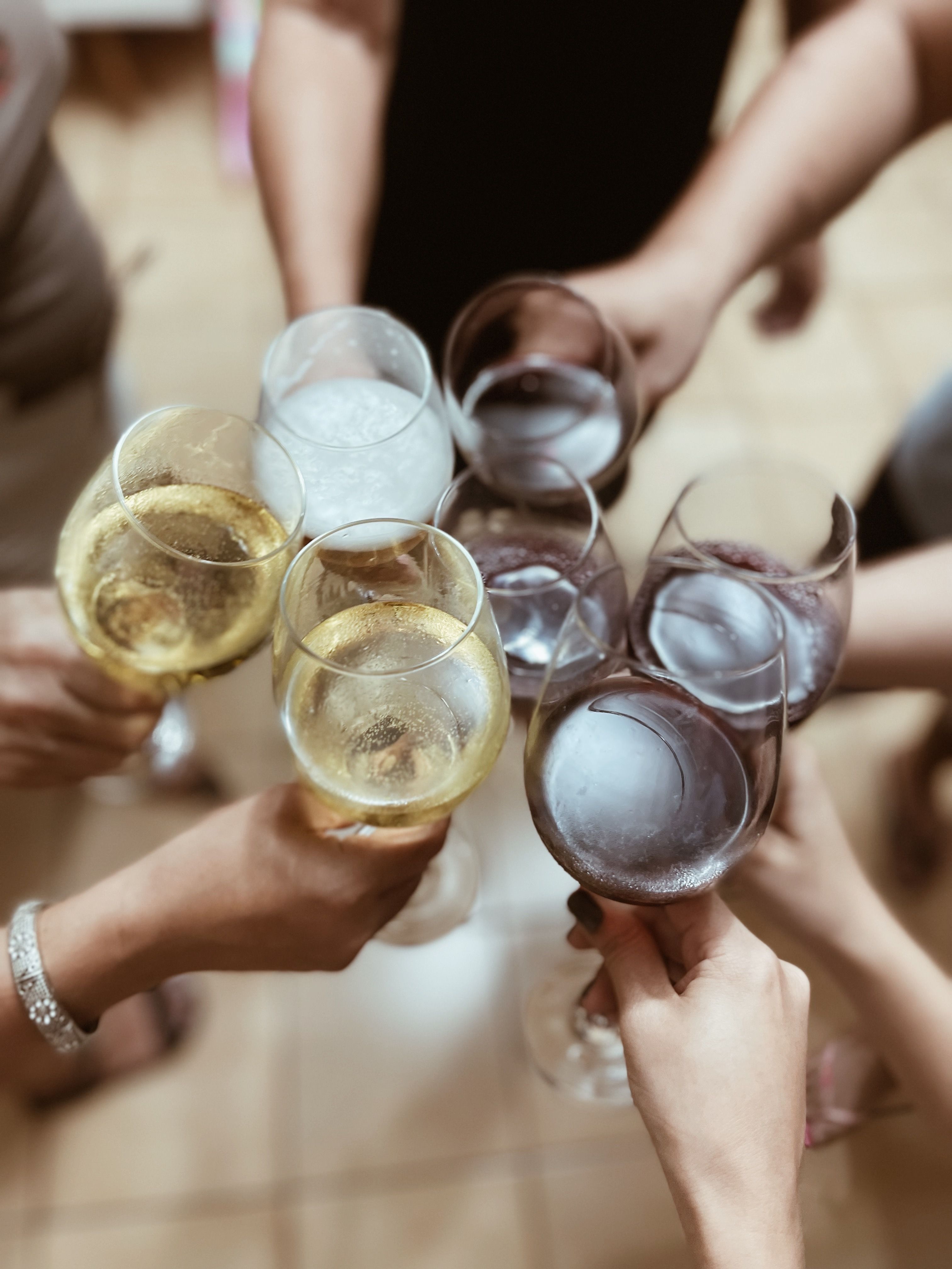 woman in white long sleeve shirt holding wine glass