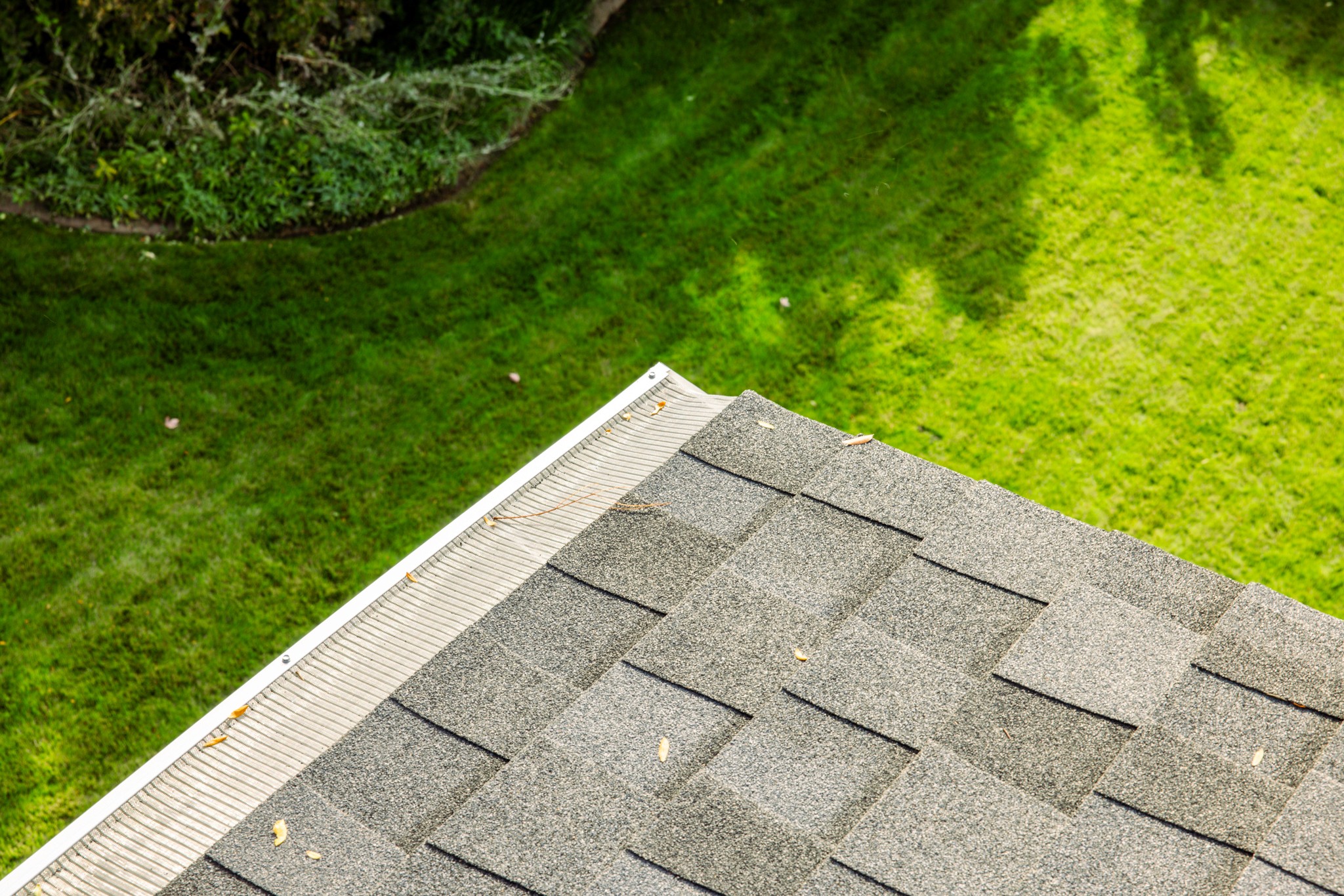 Worker installing gutter guards on Utah home