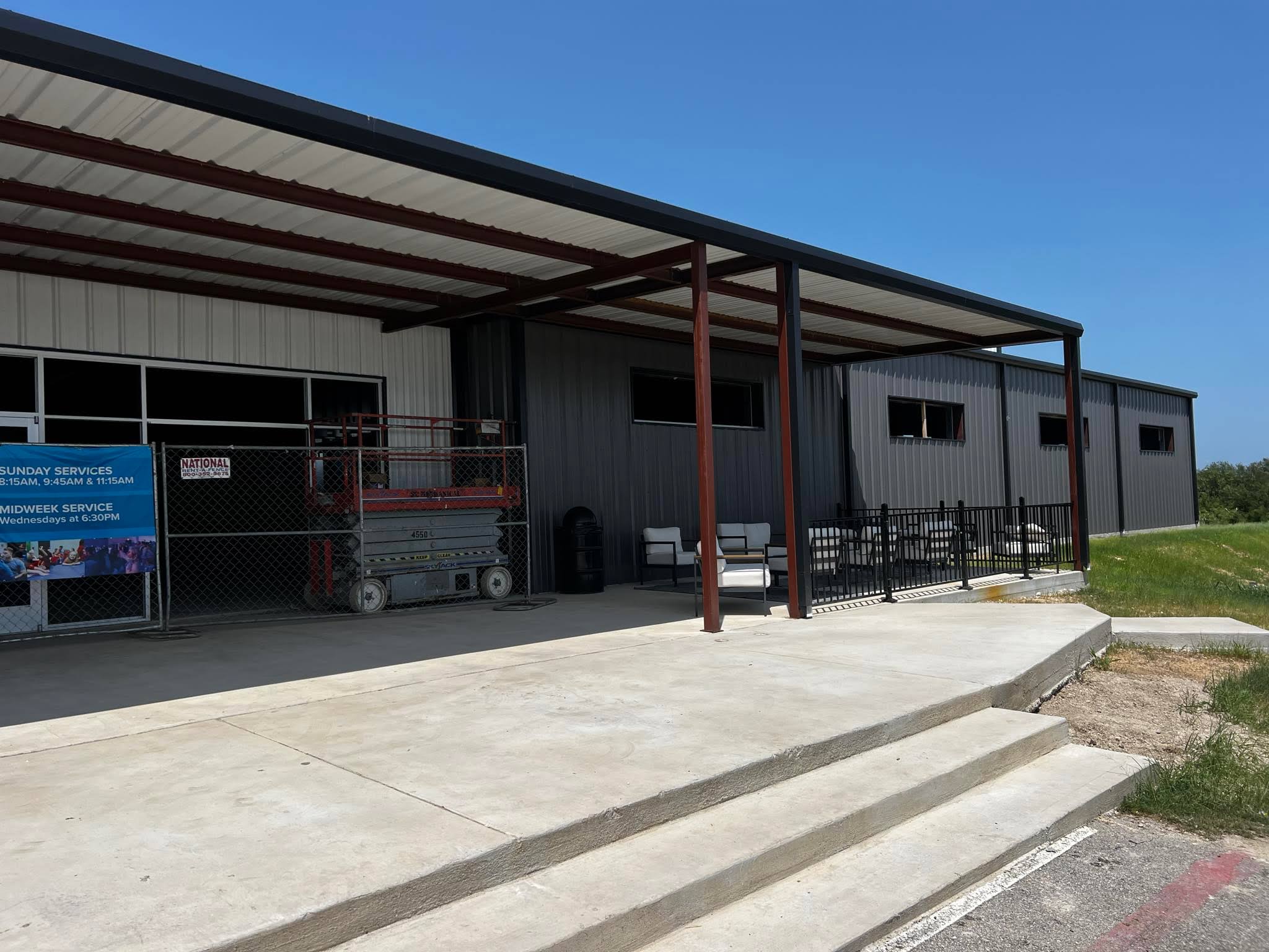 white metal building with red roof
