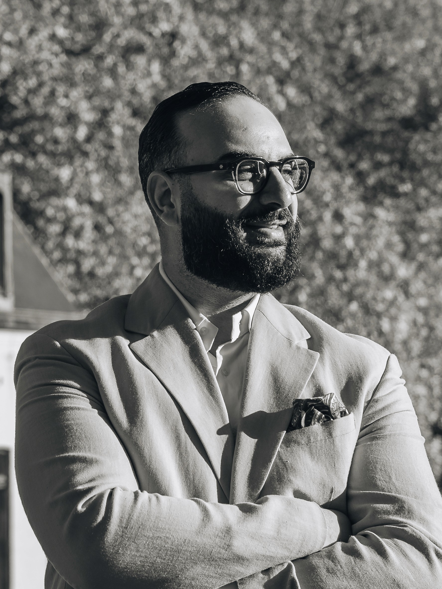 Portrait of a person in a pink sweater against a light background