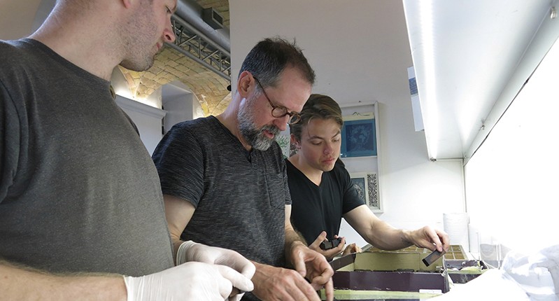 three men working together