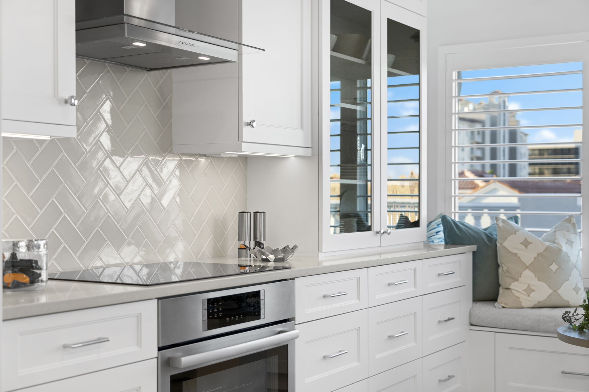 a luxury kitchen with white cabinets and a large window