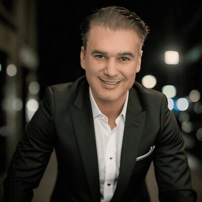 Black and white portrait of a smiling person with curly hair