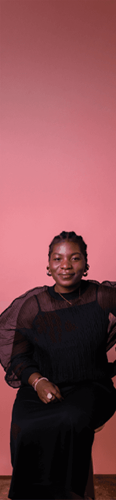 Dali Adekunle sitting in a black outfit for action shot in New York photoshoot