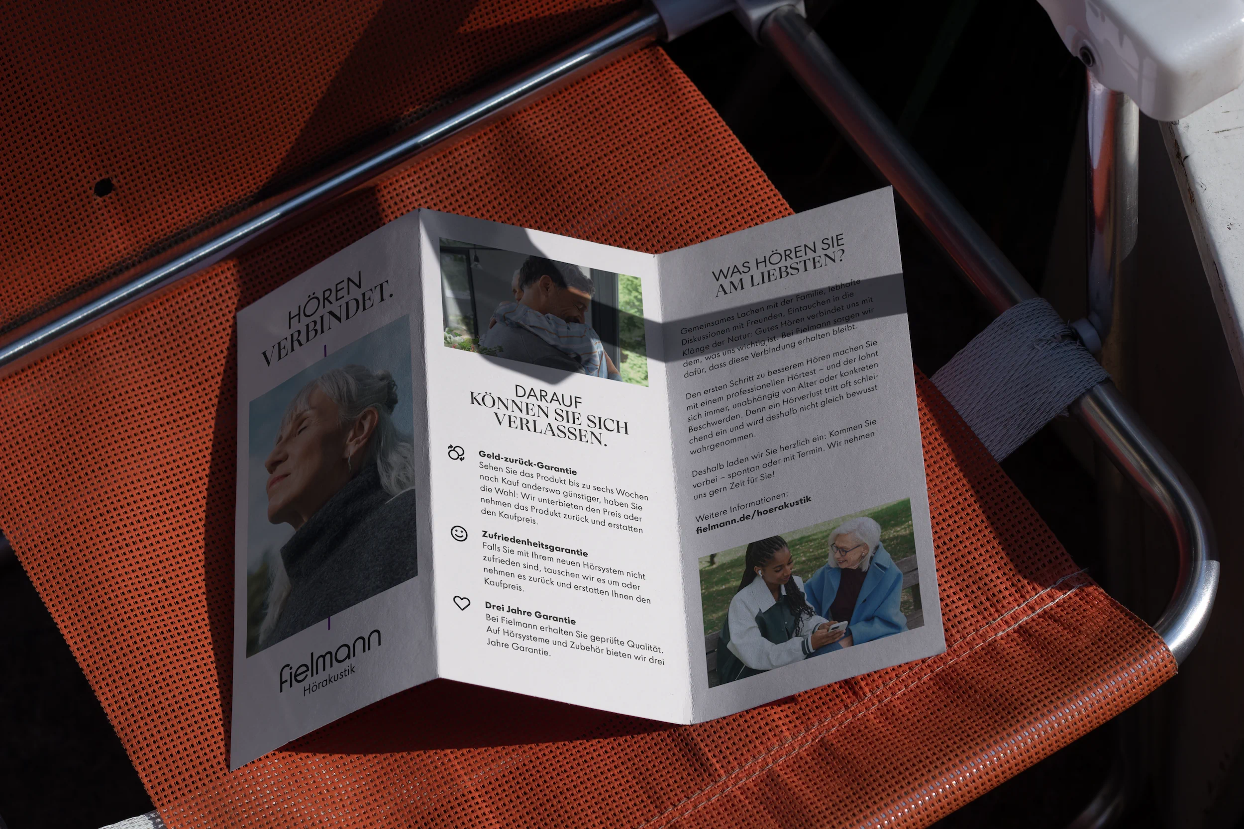 Printed Fielmann Hearing Care brochure featuring campaign imagery and customer information.