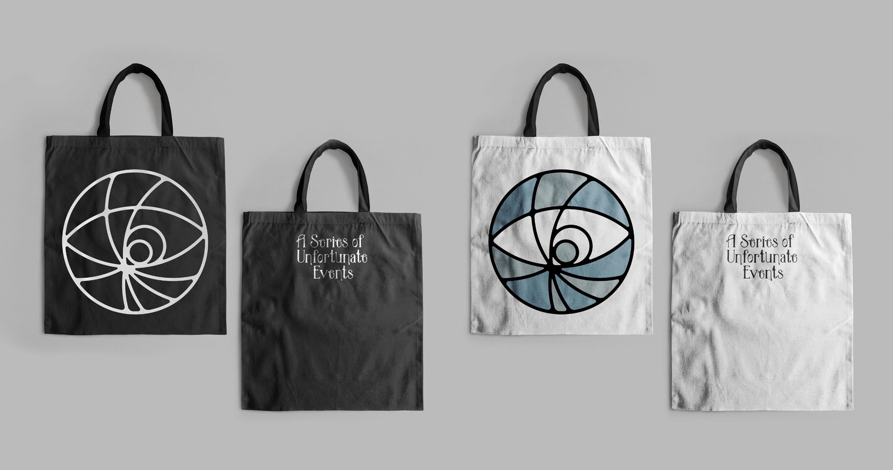 These are mockups of movie merchandise, featuring a tote back with the movie logo. There is a black bag with white text, and white bag with black text.