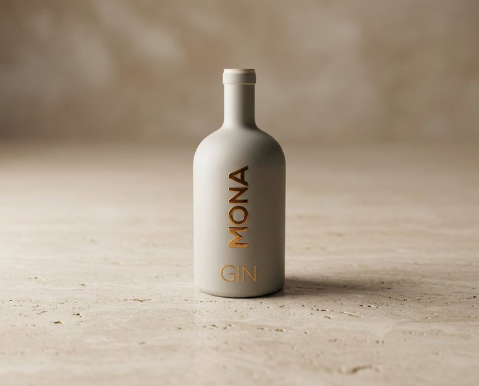 Bottle of MONA GIN on a beige surface.