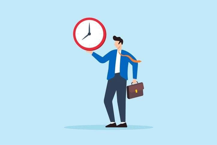 A person is arranging a professional home office workspace, adjusting their computer and notes in preparation for a virtual interview. The setup emphasizes good body language and eye contact, essential elements for a successful interview process where job seekers can confidently answer questions from hiring managers.