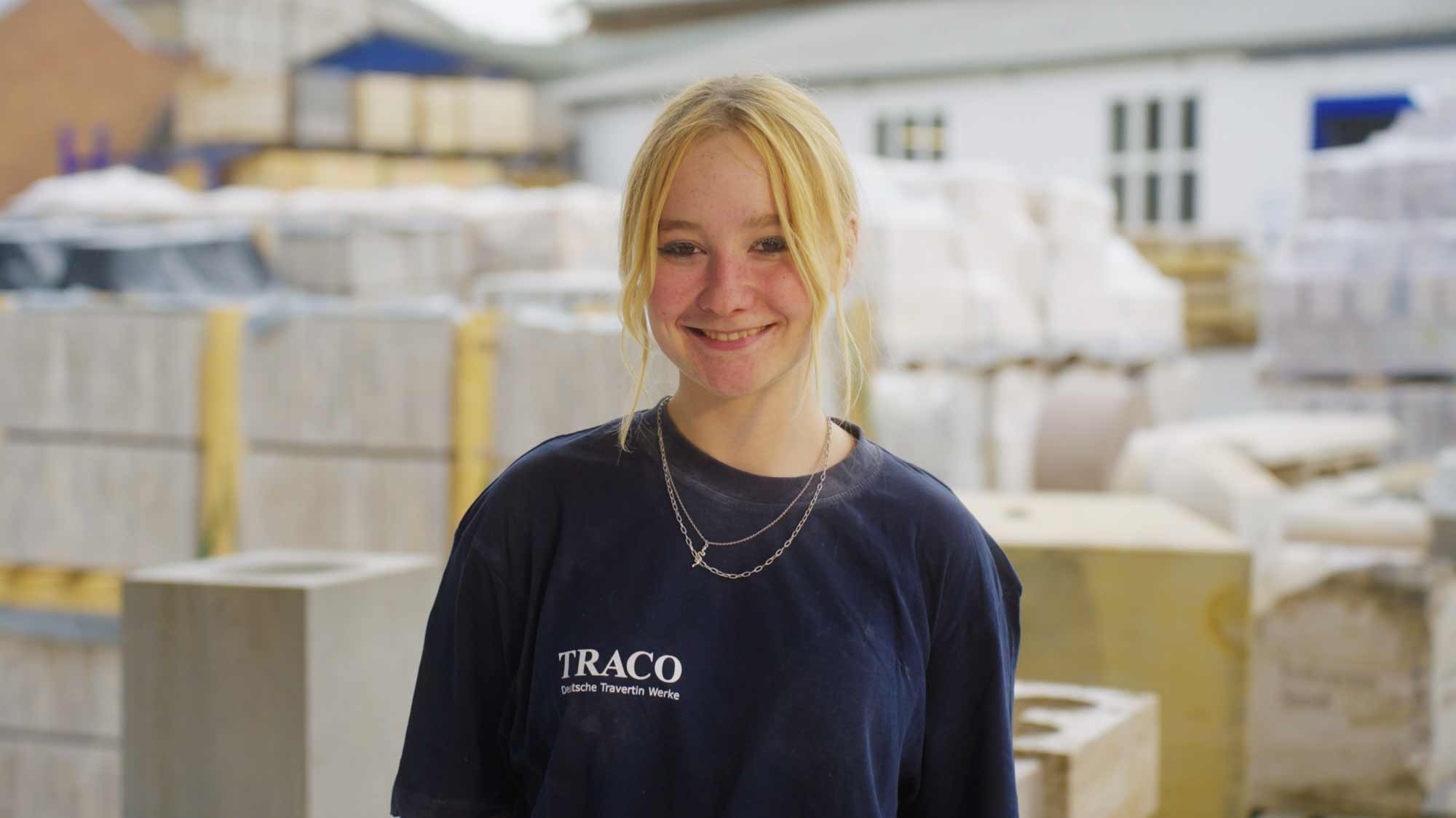 Smiling person in an industrial setting, ideal for film production, ads, and social media campaign storytelling.