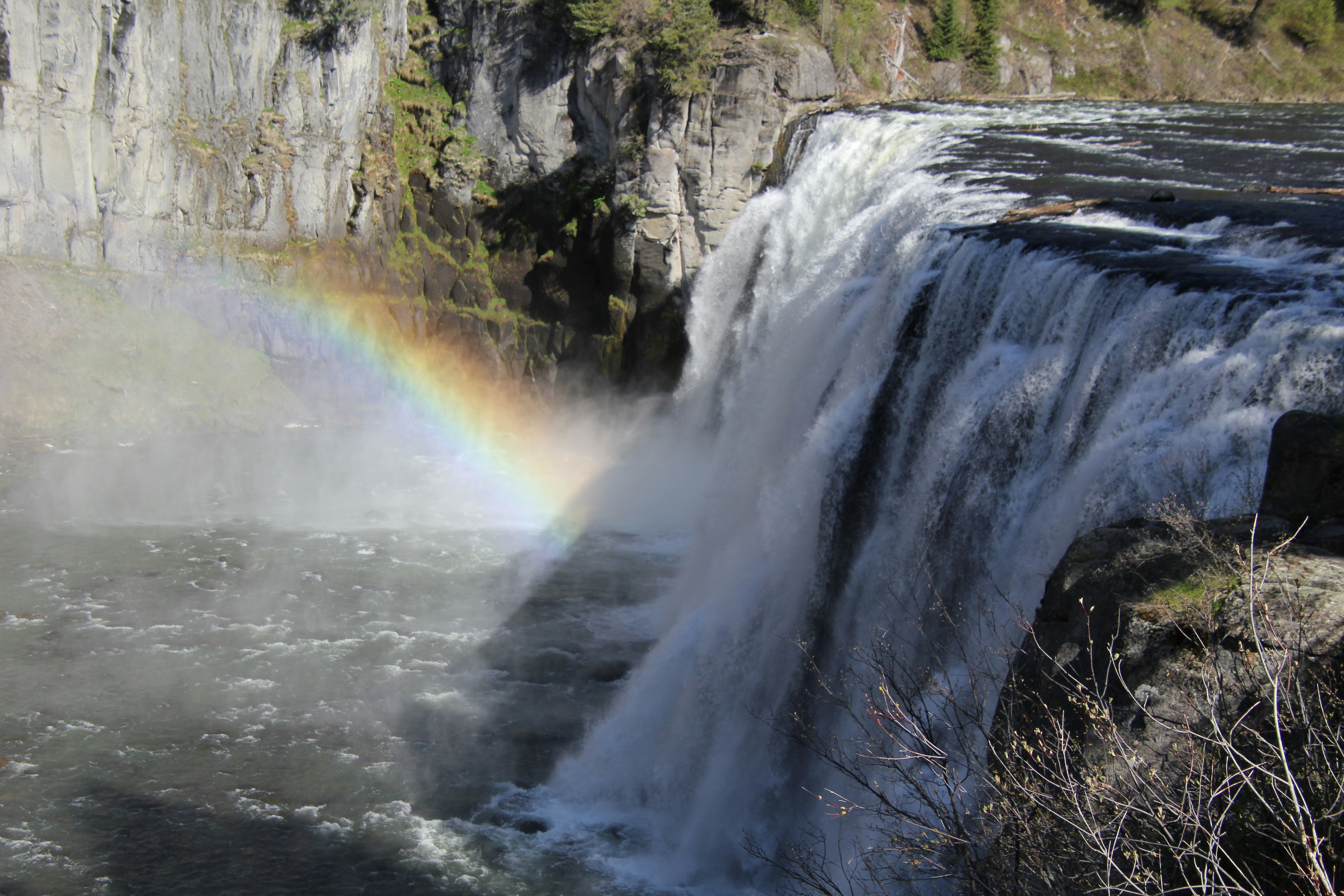 a waterfall with a rainbow