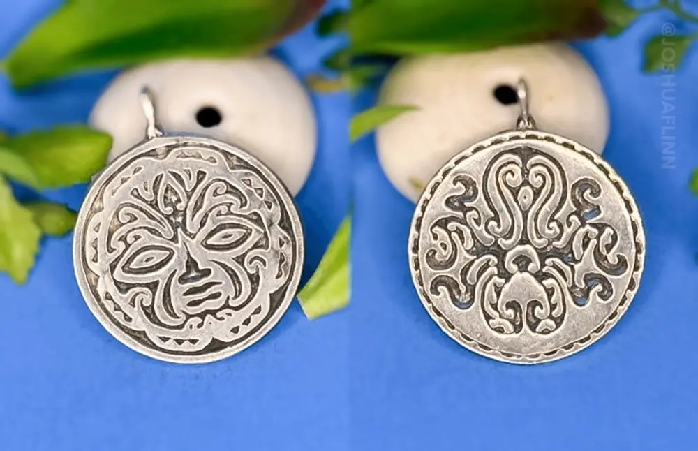 photograph of a cast silver pendant of a polynesian tribal face and squid front and back