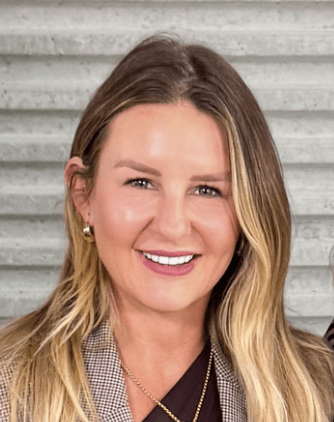 a man with a goatee smiles at the camera