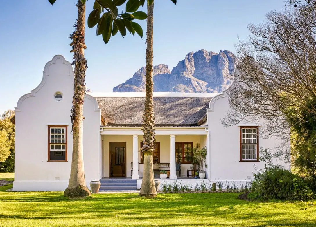 Champagne Farmhouse exterior beneath the mountains