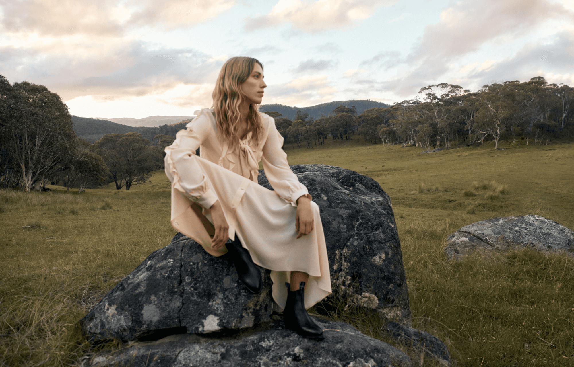 Woman sitting on rocks wearing R.M. William boots