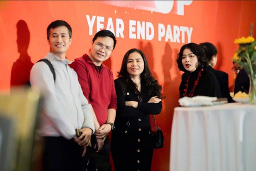 woman in blue tank top standing beside white wall