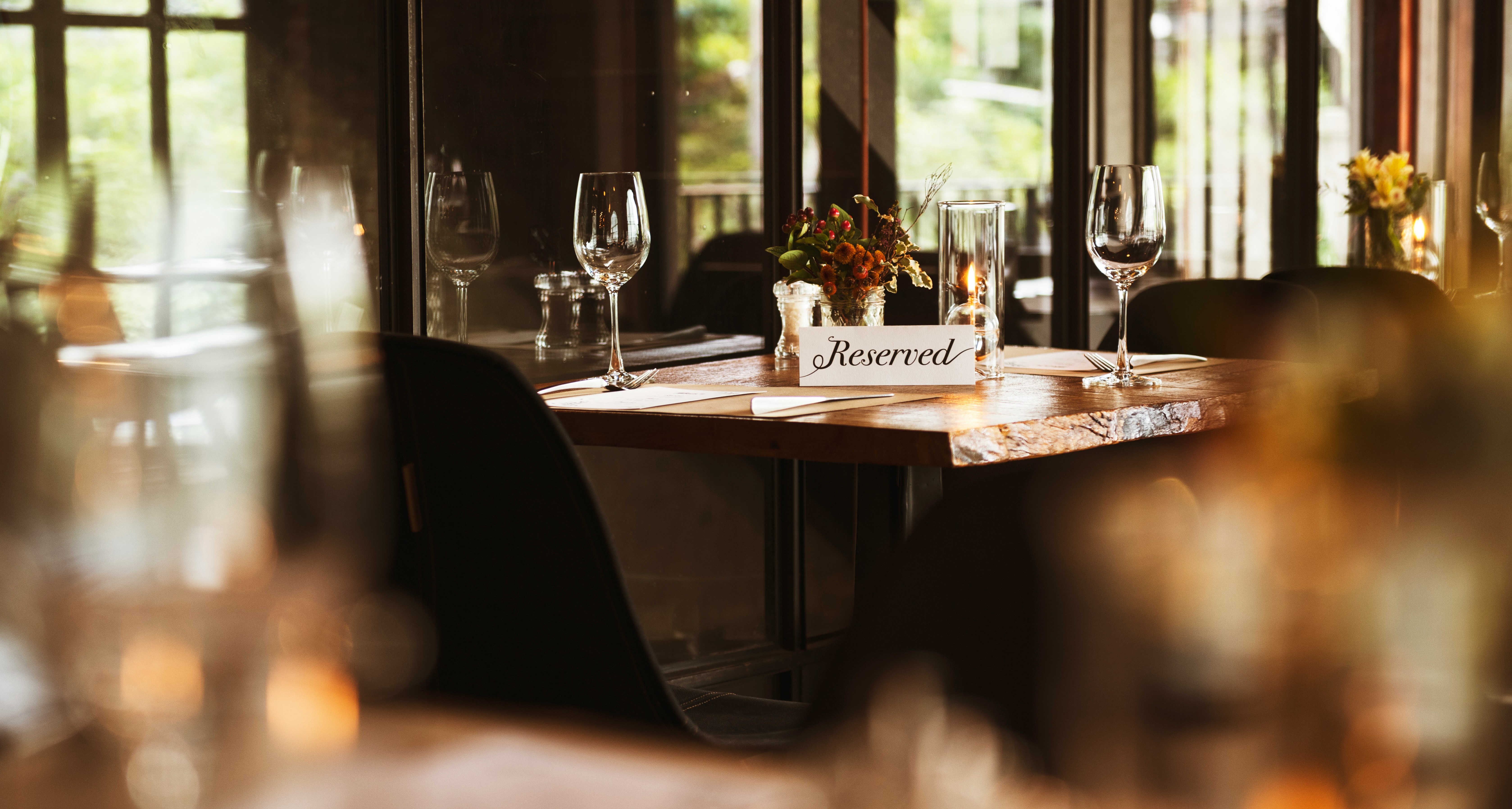 Restaurant table with a reservation note.