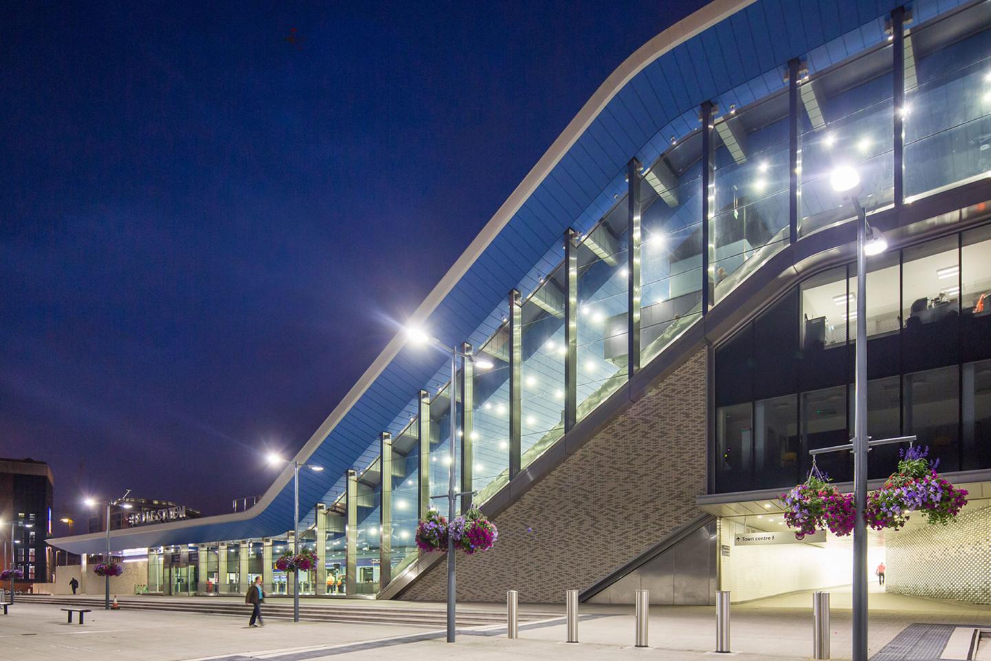 Modern part of Reading train station at night with multiple lights