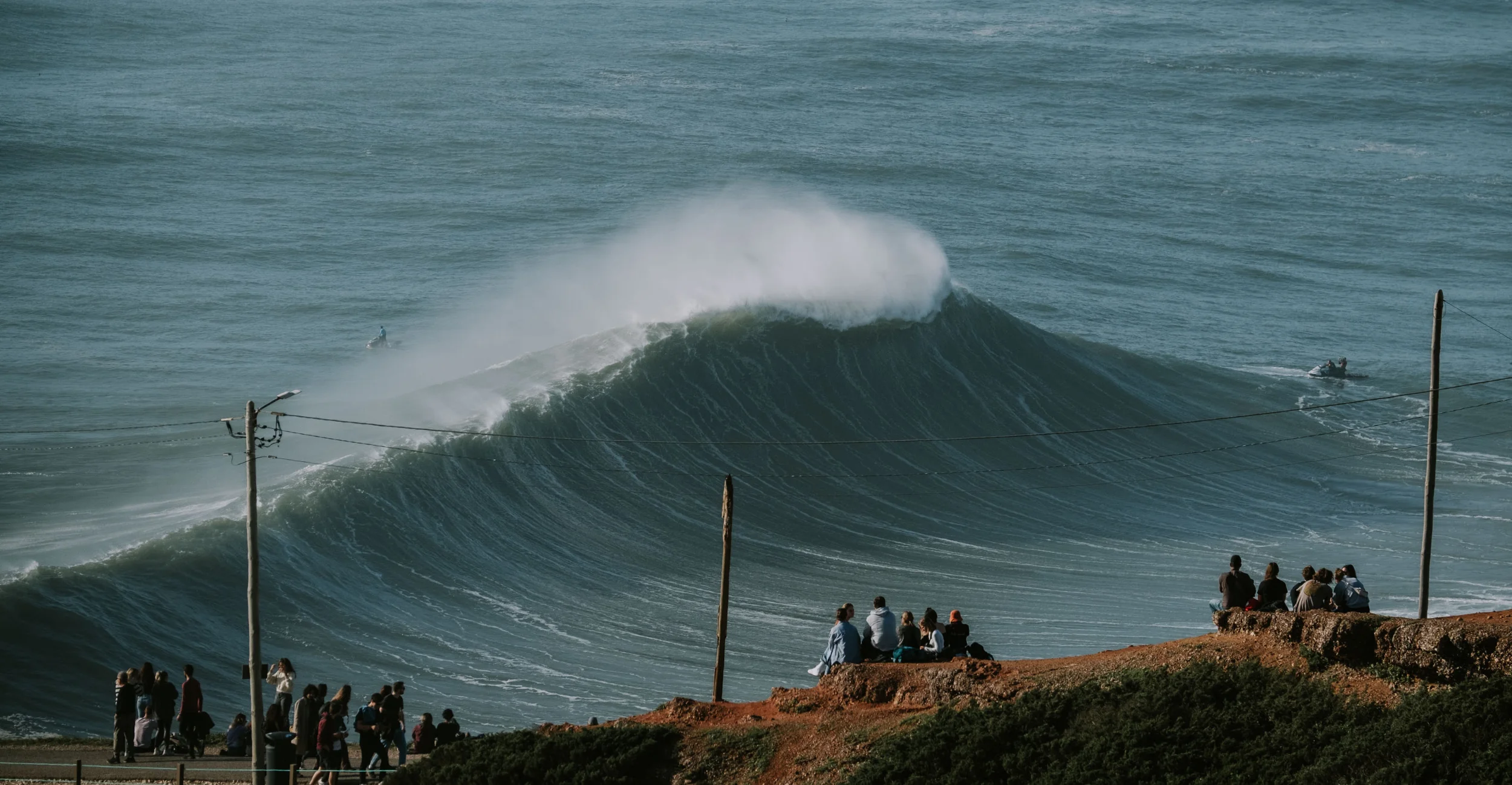 View from land on a big wave in Nazare