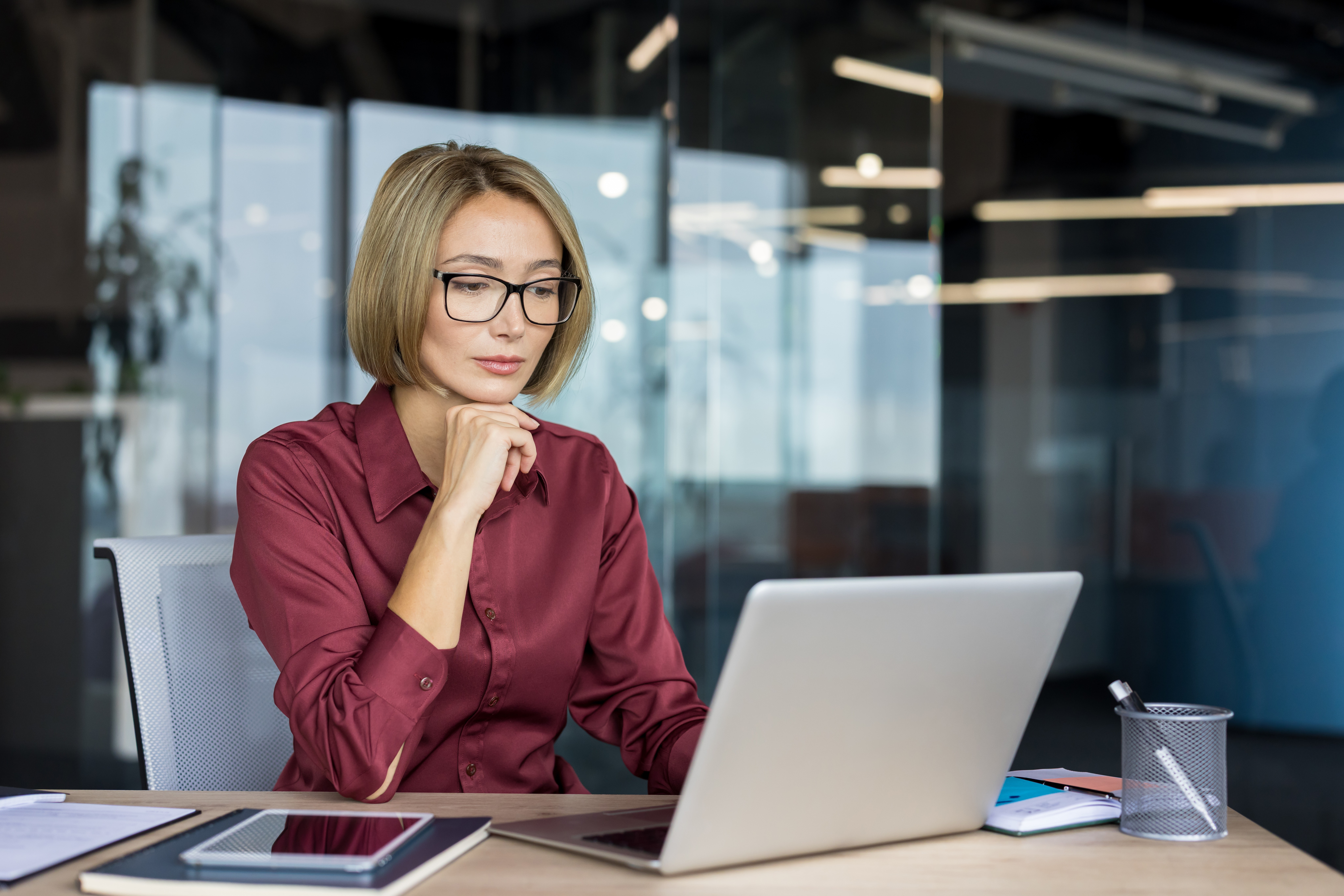 Professional working at a laptop, developing targeted skills to solve a specific business problem
