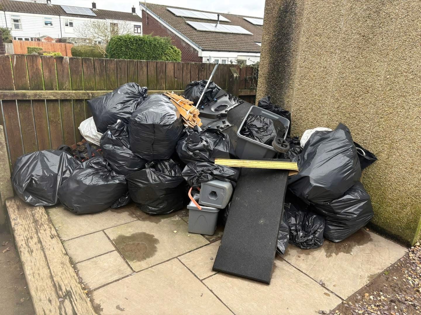 Bagged household waste and bulky items awaiting collection