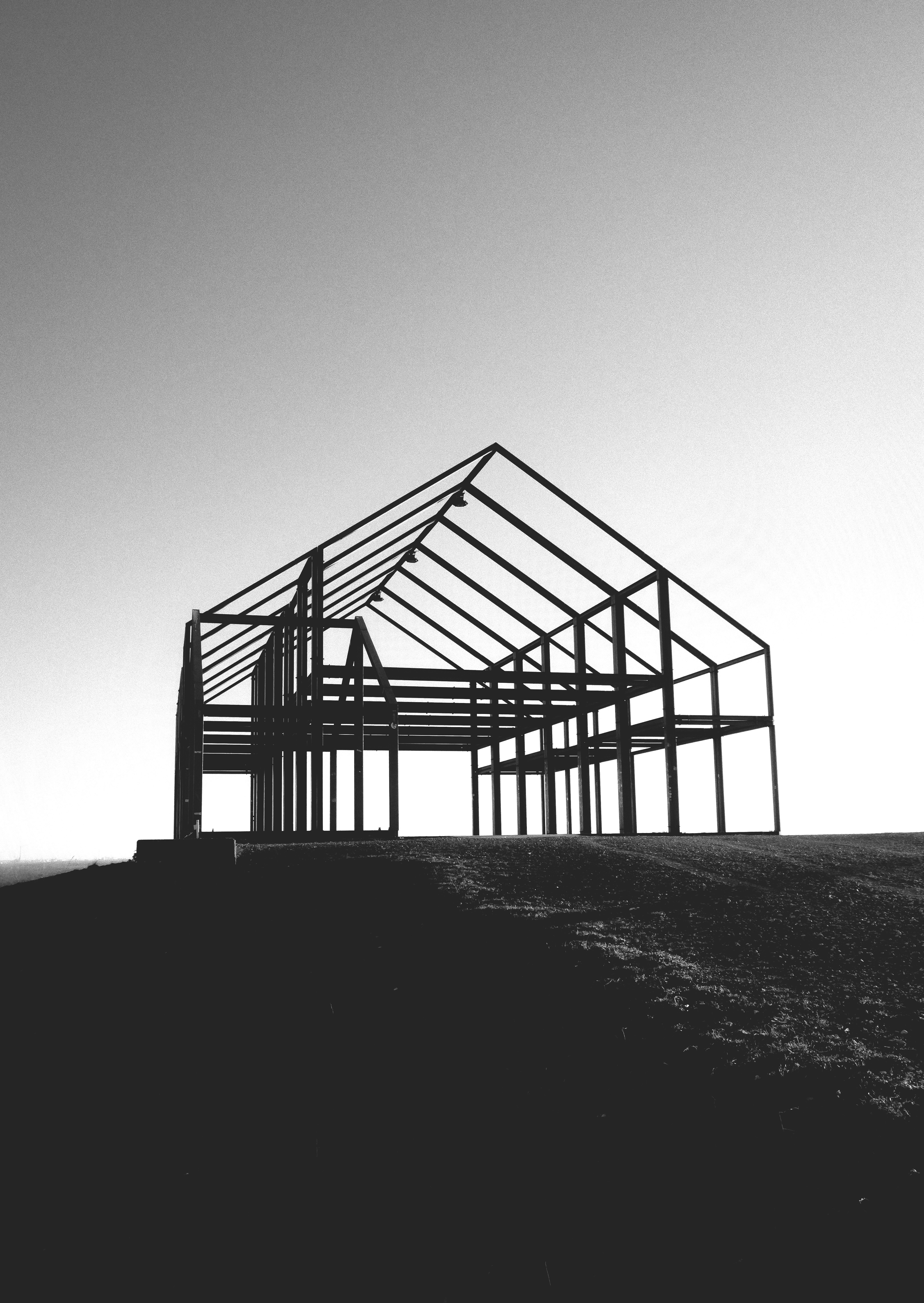 a black and white photo of a building under construction