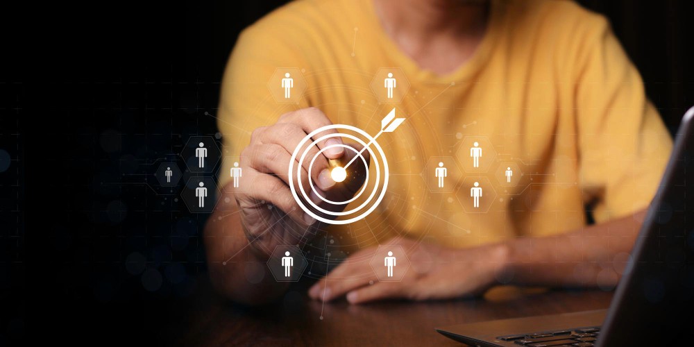 Una persona trabajando en un portátil con diagramas de flujo de leads flotando alrededor