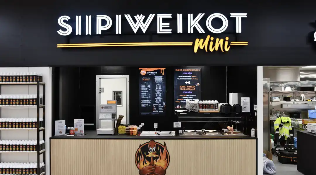 Trendy spot with Siipiweikot sign, popular for their hot wings