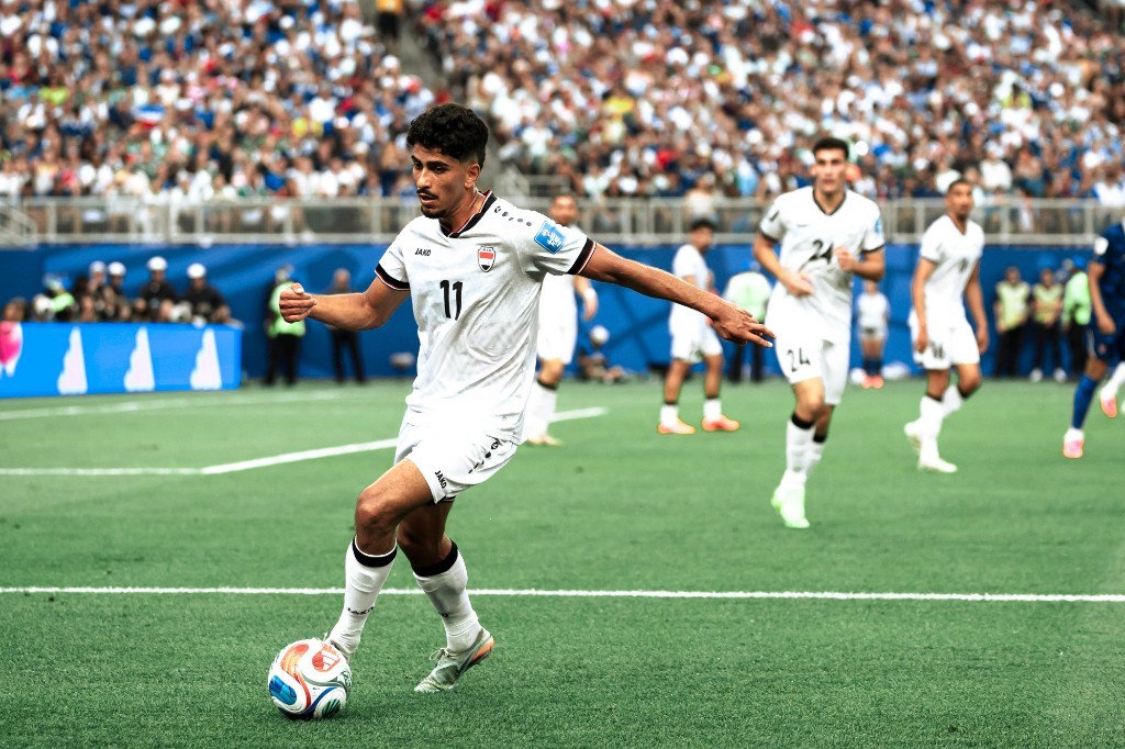Iraq's number 11 dribbles under pressure during the World Cup group-stage match against France