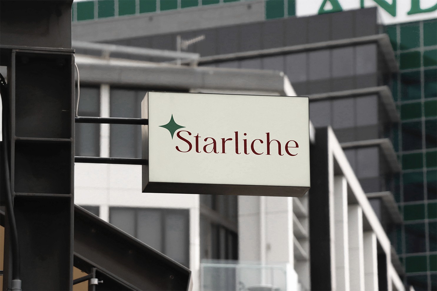 Minimalist outdoor architectural exterior lightbox sign showcasing the corporate Starliche serif wordmark and green four point star emblem on a clean cream background.