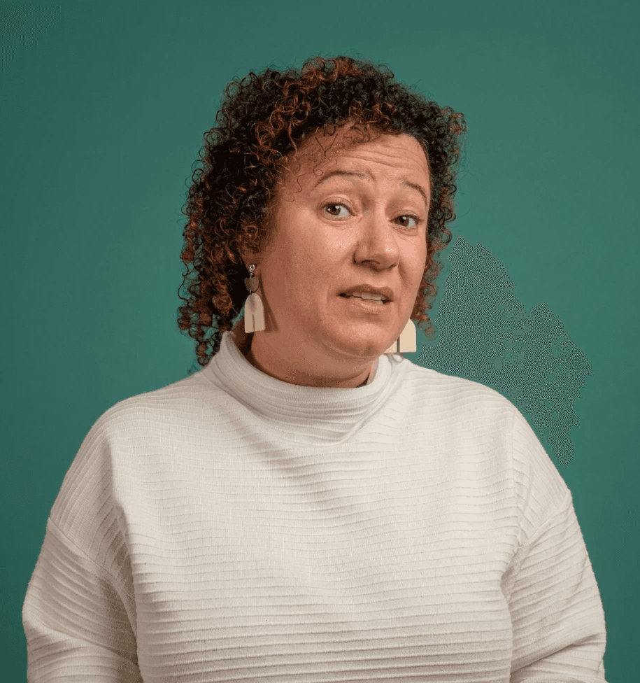 smiling woman sitting on grass during daytime