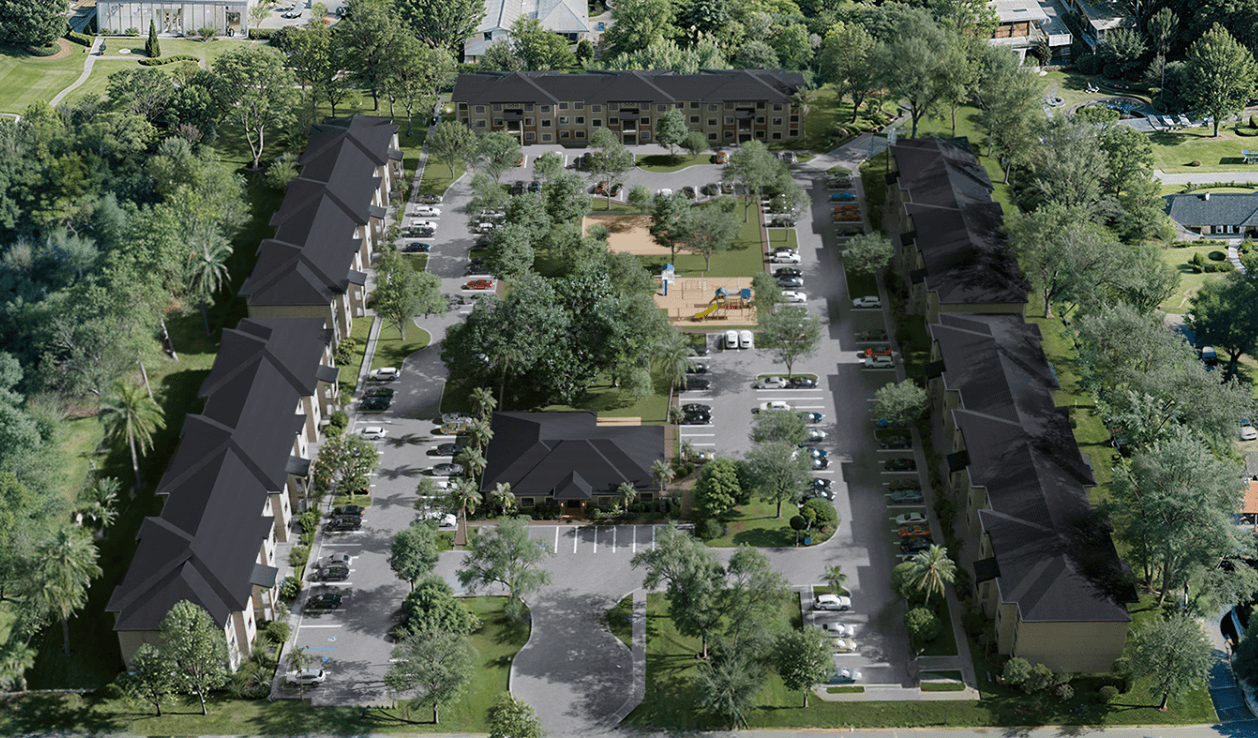 Aerial view of Residences at East End showing residential complex with landscaping, parking, and surrounding neighborhood