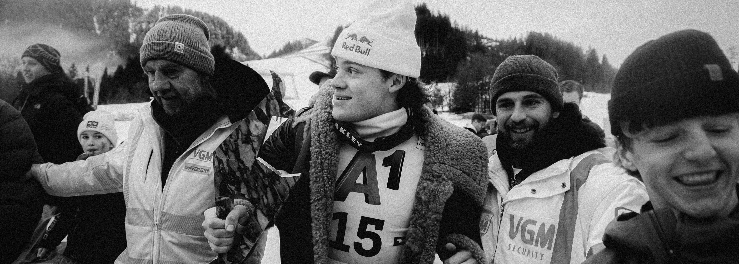 Lucas Pinheiro Braathen surrounded by his support crew during a competition event.