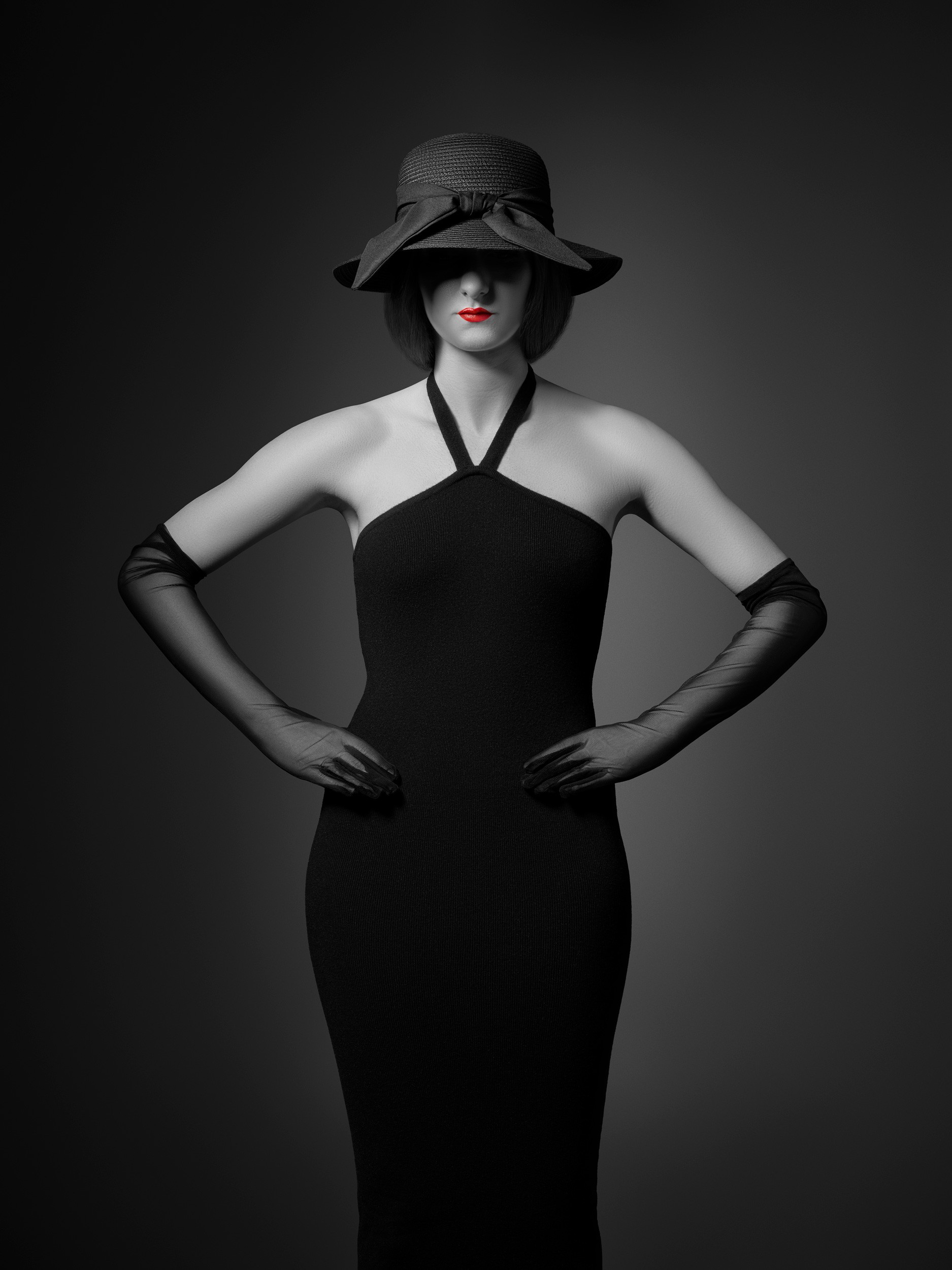 An elegantly dressed model wearing Dior Rouge Satin 999 lipstick photographer by Matthew Brown.