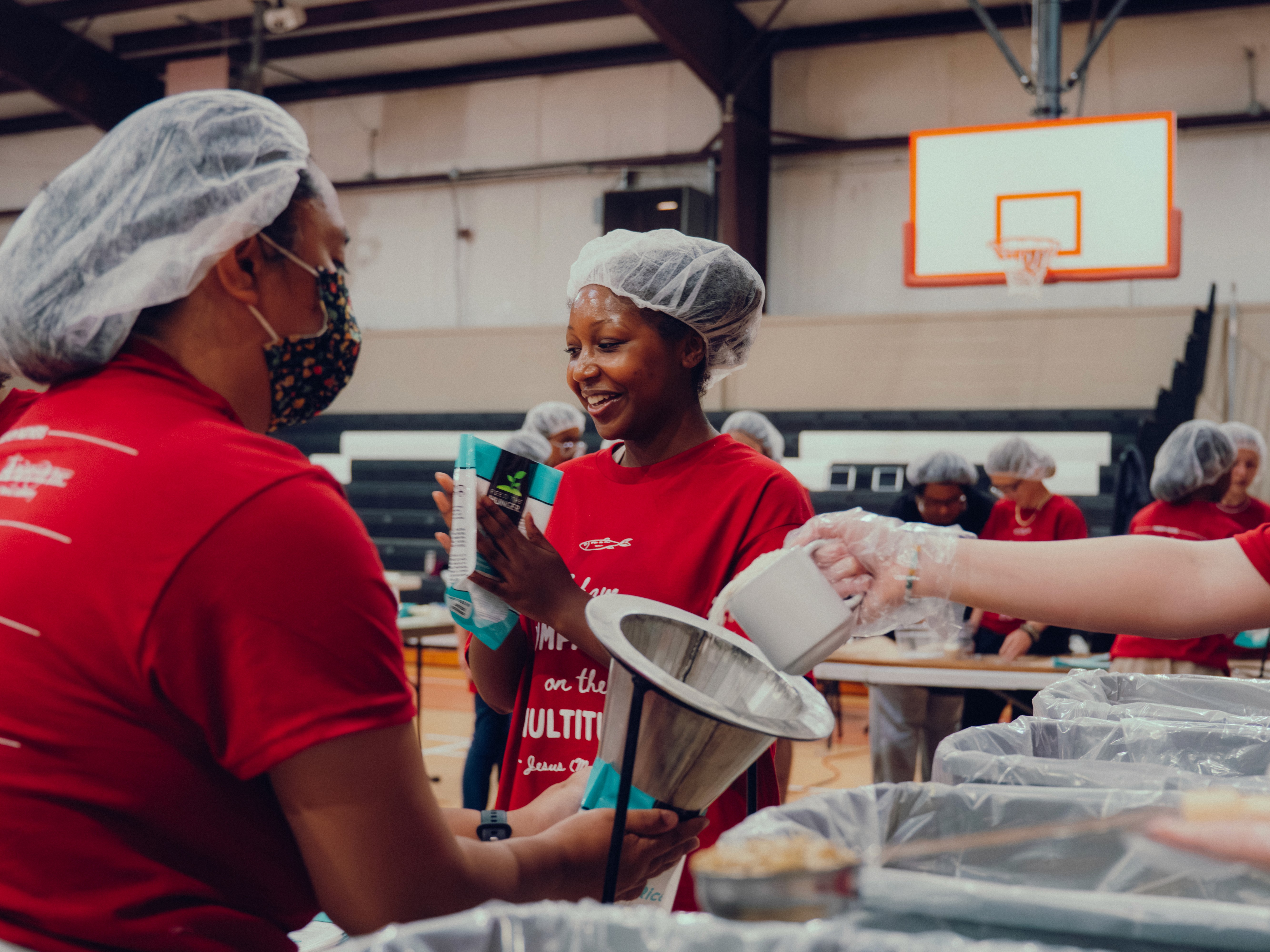 A student packaging food to send overseas for families that need food for our Feed the Need service event at Bible Baptist Christian School