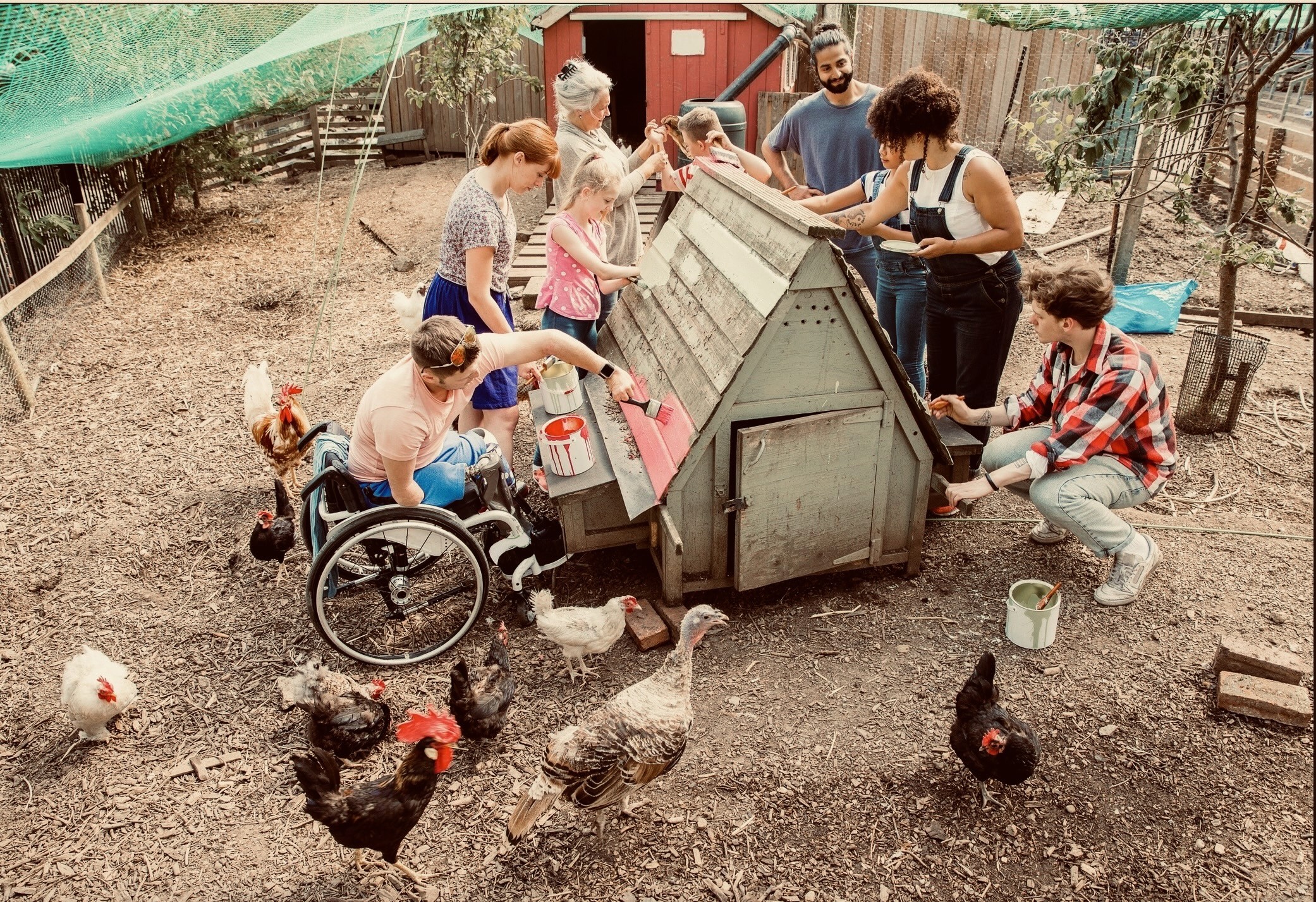 2 boys sitting on red and black ride on toy car