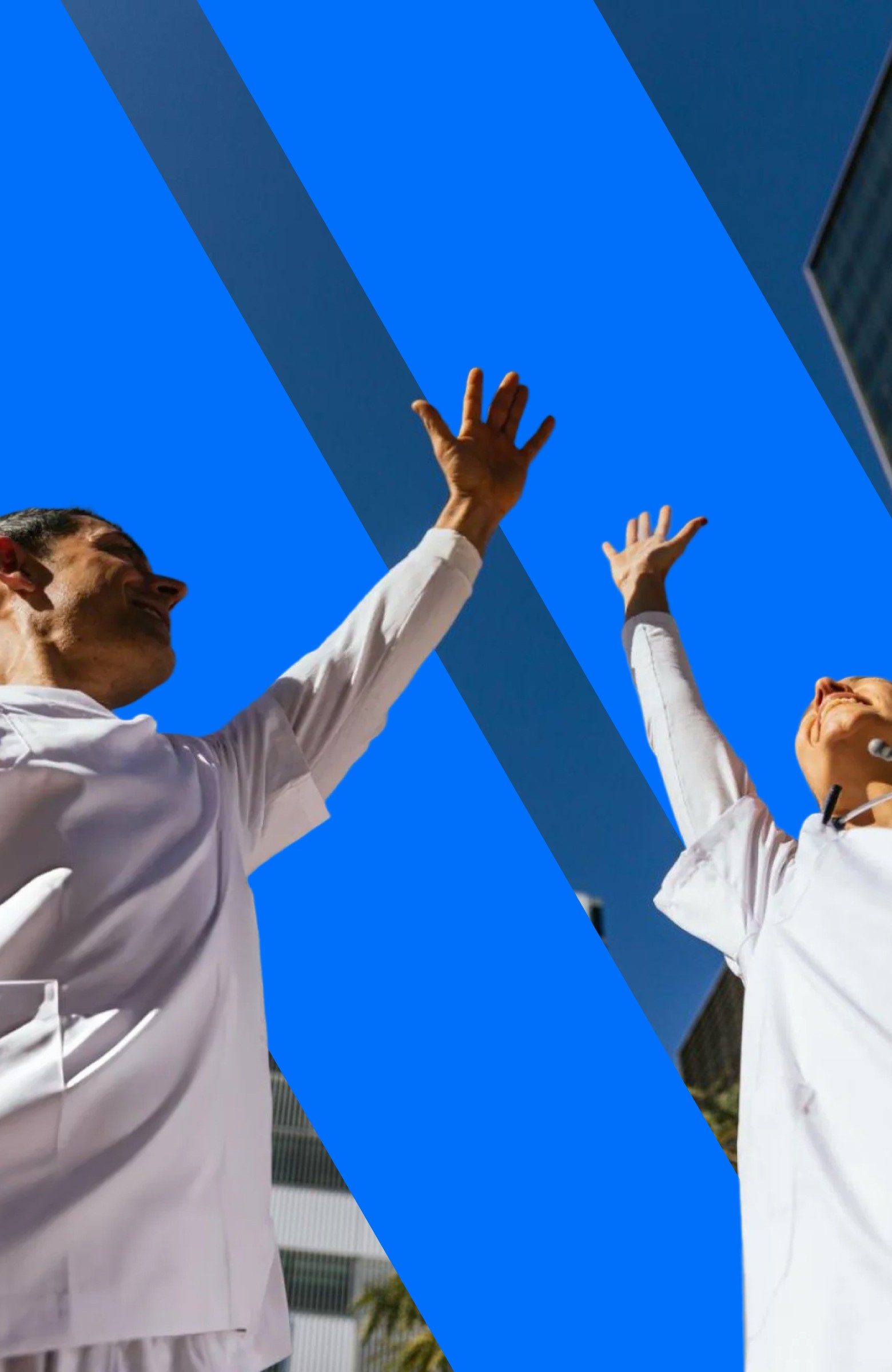 two people in a workspace working on their laptops