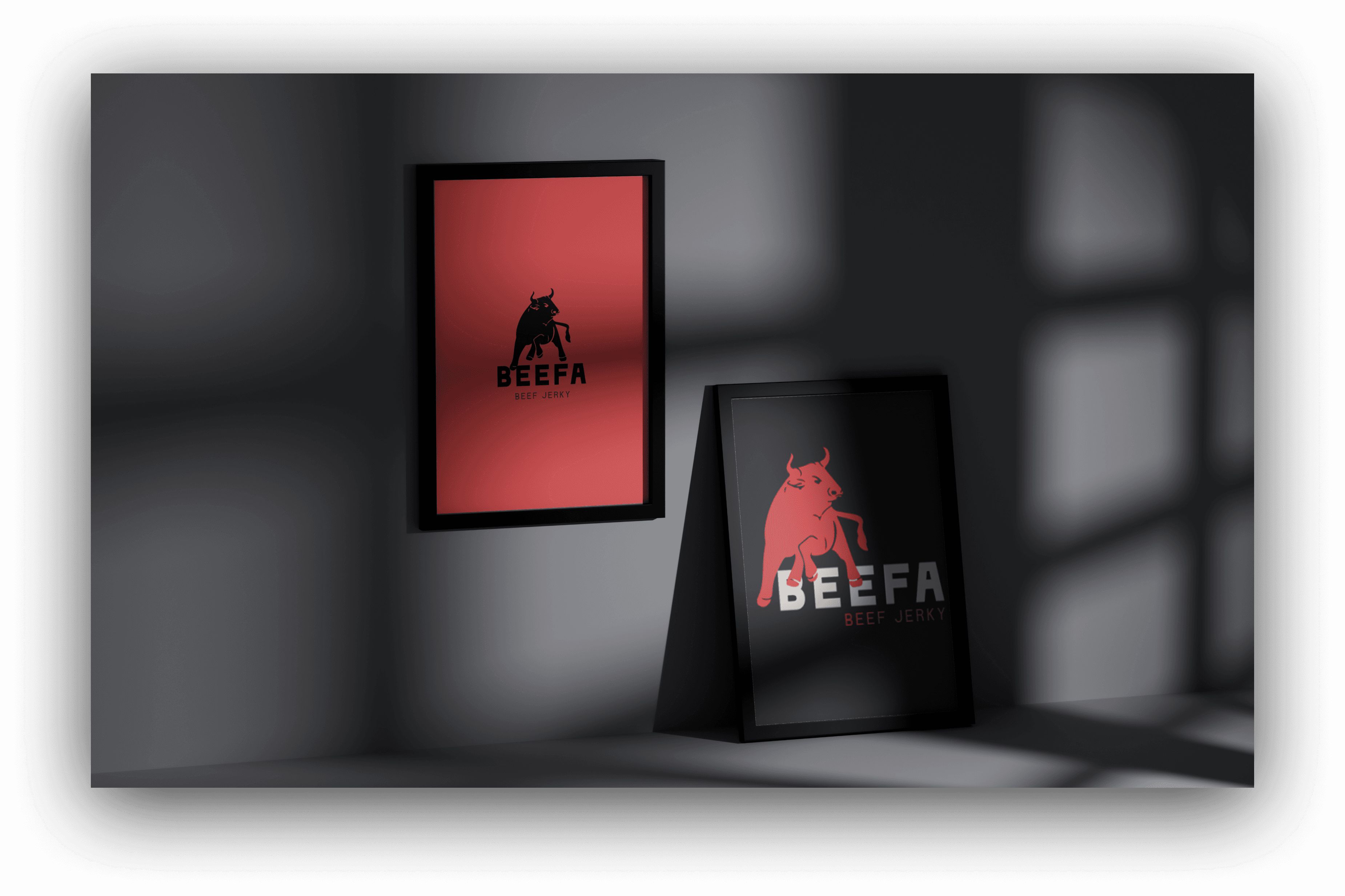 Two framed Beefa jerky logo designs by The Editor Suite are displayed against a gray wall with dramatic window shadows. One framed poster features a black bull on red, while the other showcases a red bull on black, demonstrating logo variations. This image highlights the visual branding created for Beefa.