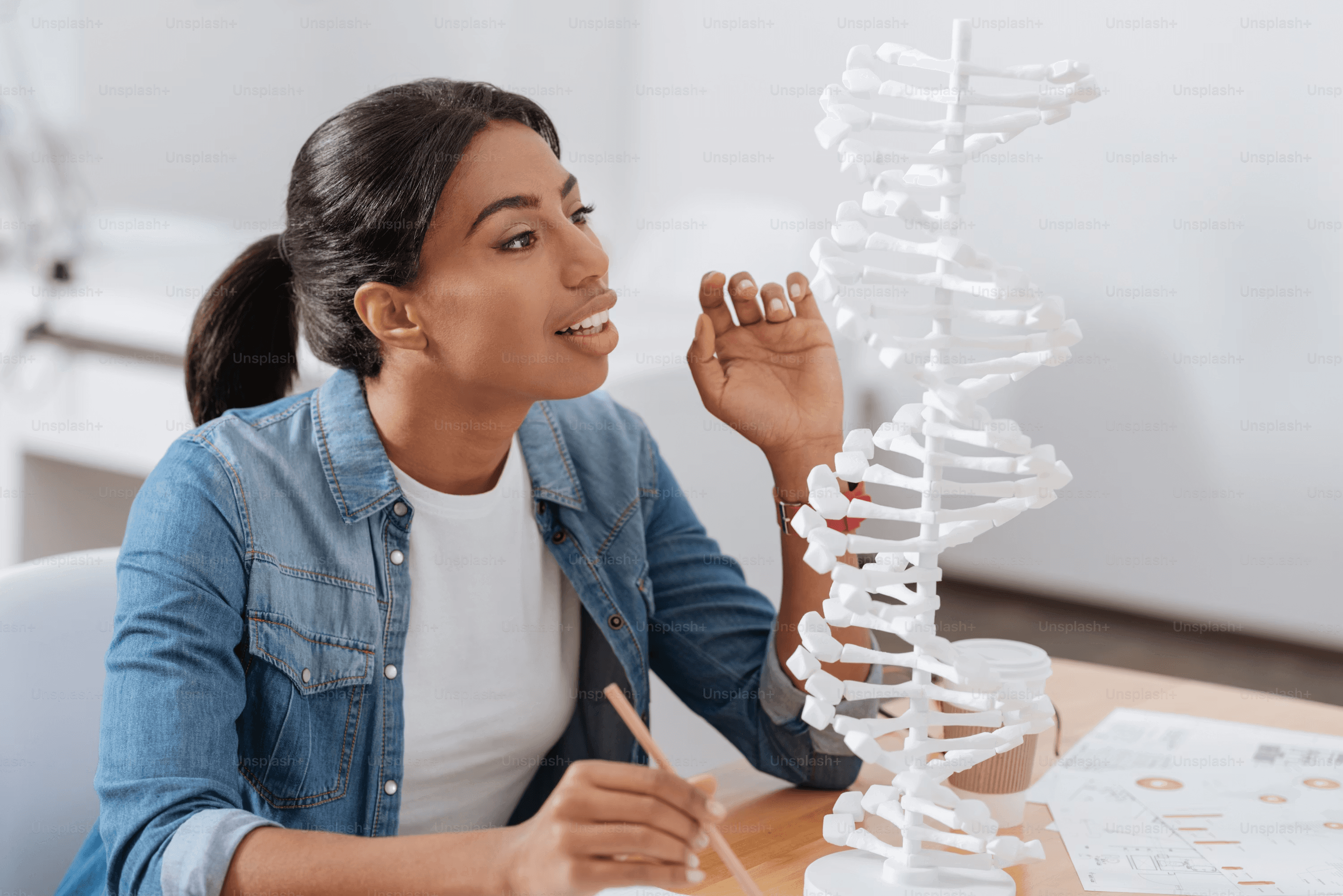 High school student conducting genetics research under PhD mentor guidance at a university lab