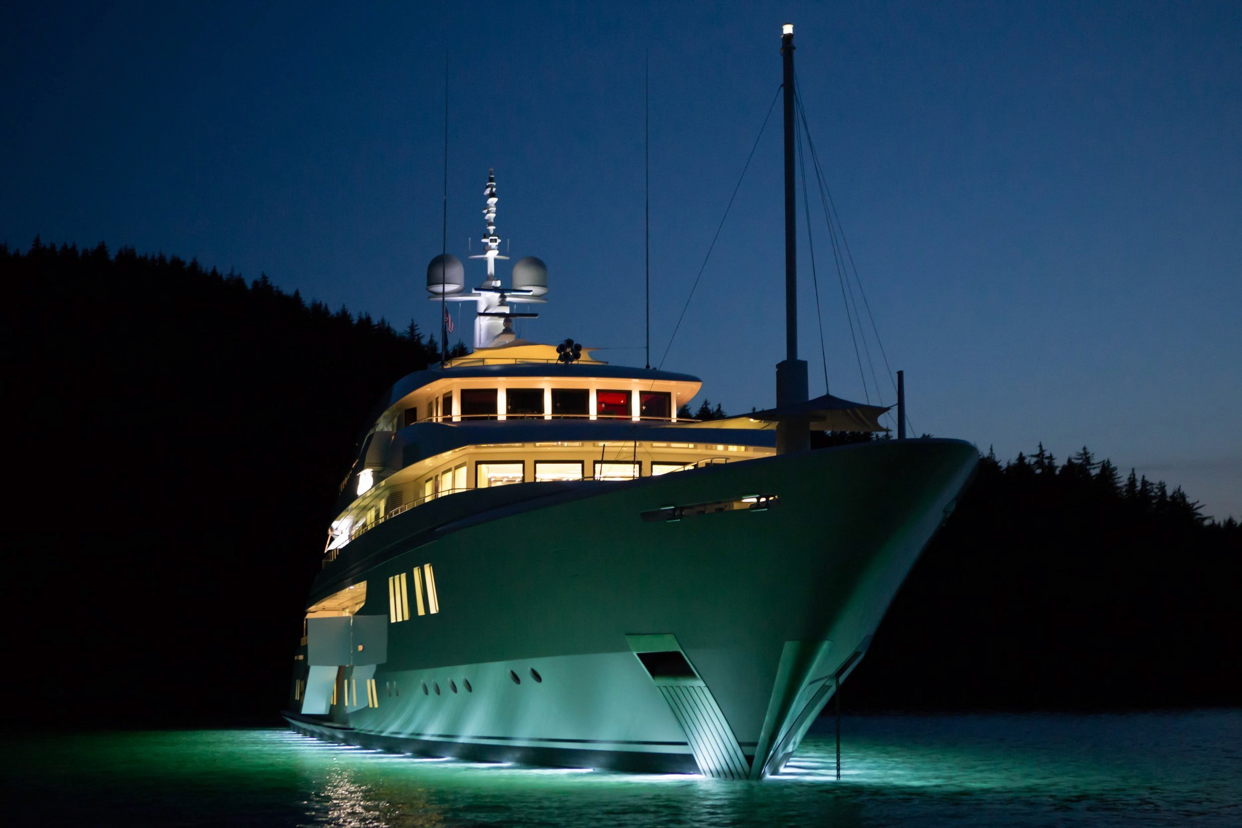 Large yacht illuminated at night in calm water
