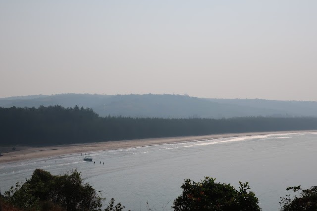 A beautiful beach with hills in the background. A view on our Konkan road trip.