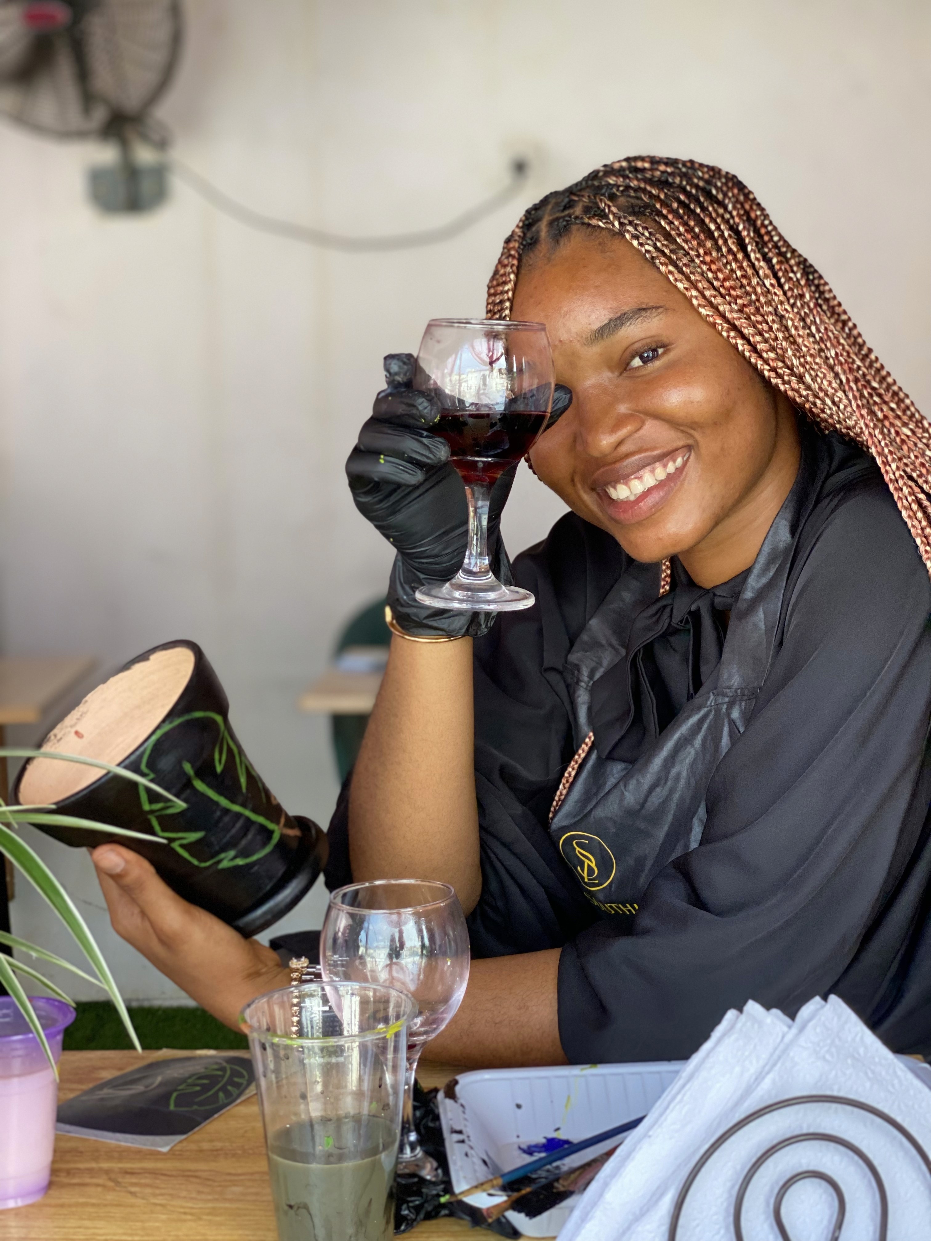 Chef Xan smiling and drinking a wine